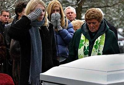 Bethany Landeck salues her husband's coffin at his funeral Feb. 12